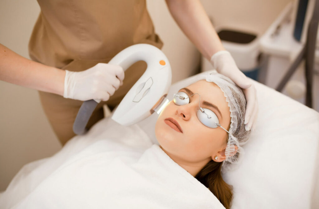 A young woman is undergoing IPL therapy for dry eye treatments.