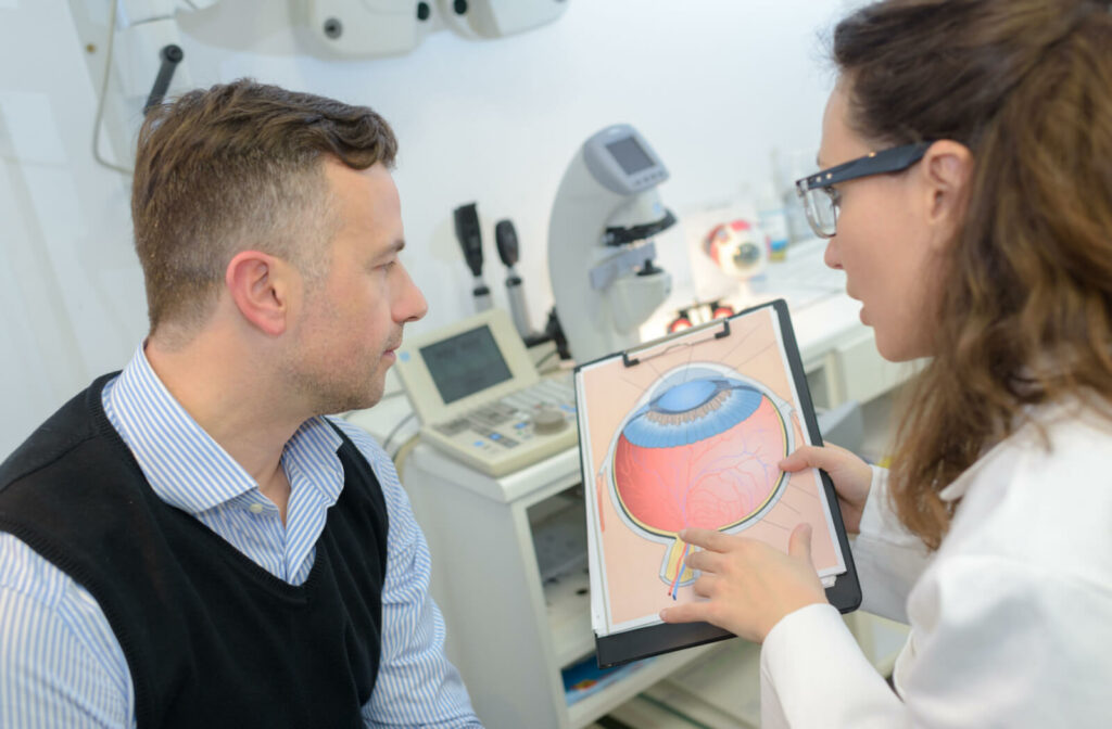 "A man sitting in an optometry practice while the eye doctor is explaining how glaucoma affects the eye."