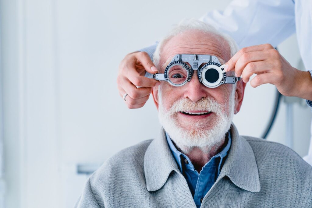 An image of an older man having his eyes measured for Neurolenses during an eye exam.
