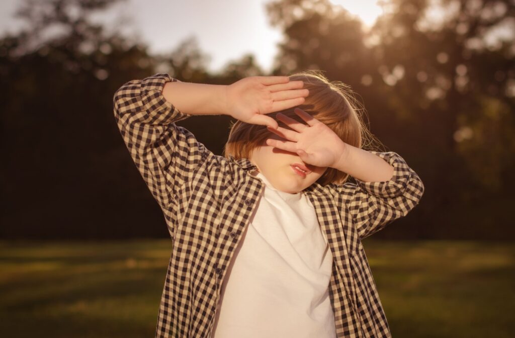 A child experiences light sensitivity after hitting their head, indicating that they may have a concussion.