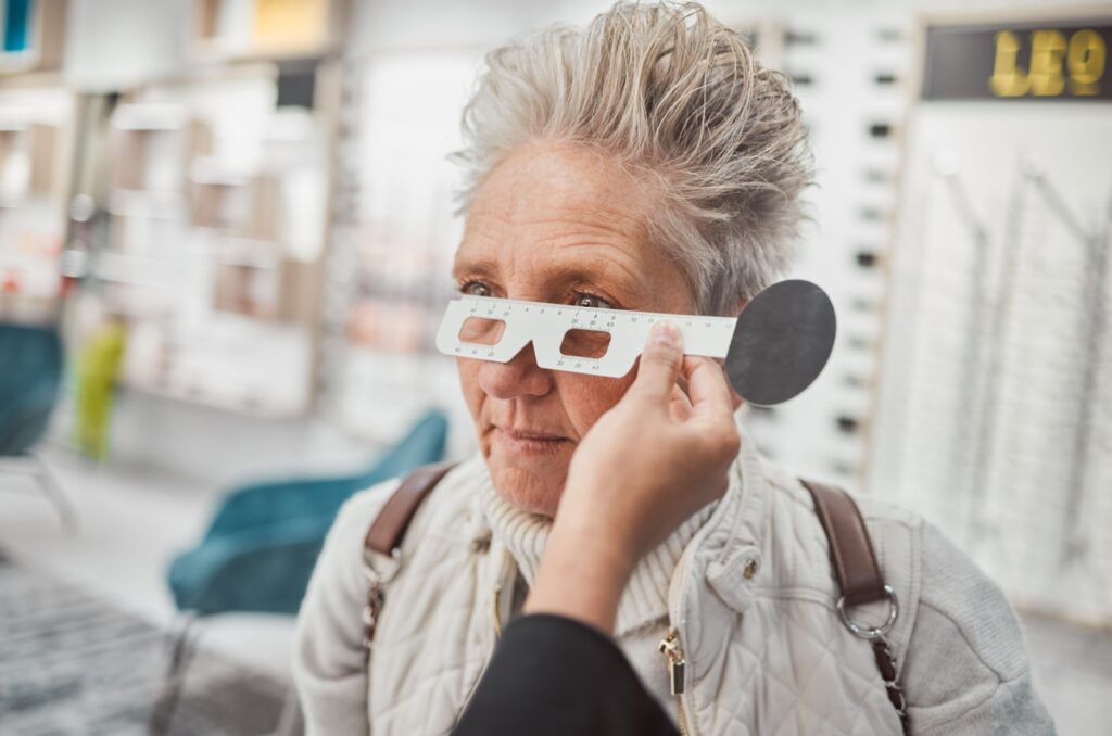 A close-up image of an optometrist measuring a patient's pupillary distance for correct glasses fit.