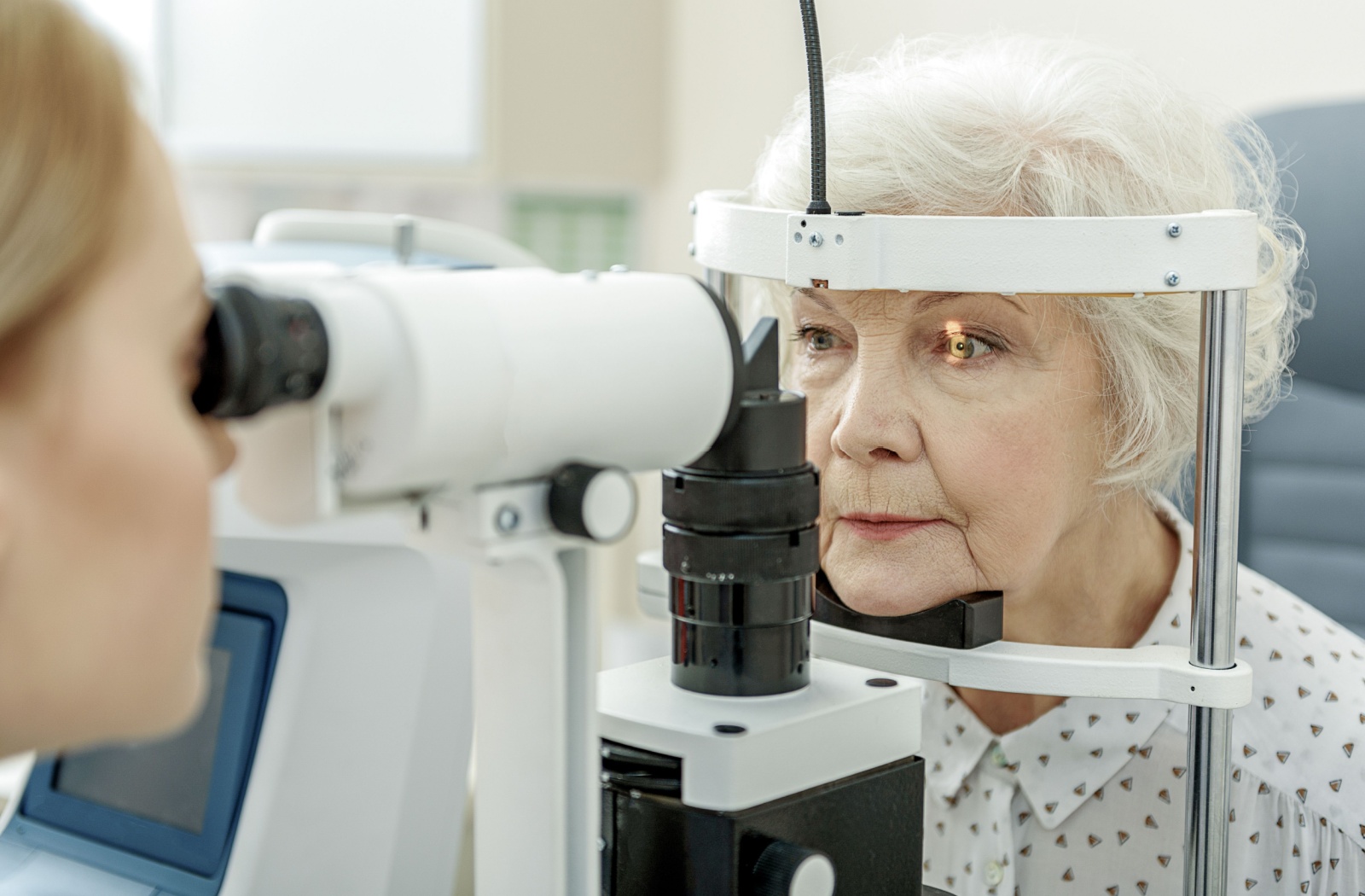 Senior receiving an eye exam at an optometry office.